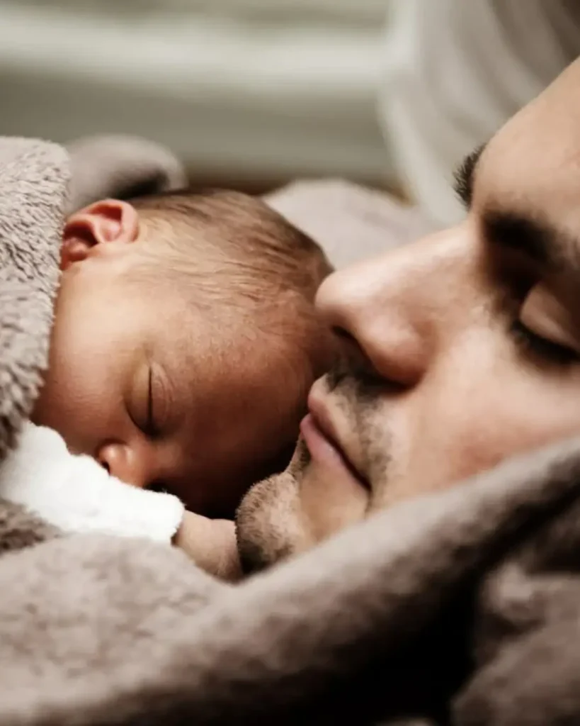 Close up of a Dad and his Little Baby Sleeping Together