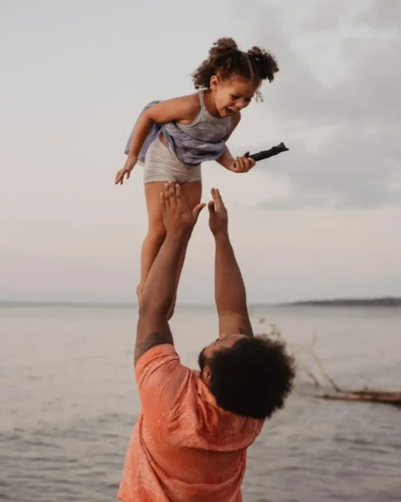 Father And Child Having Fun on the Beach