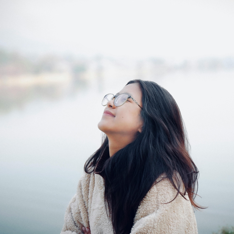 Serene Woman Enjoying Peaceful Lakeside View