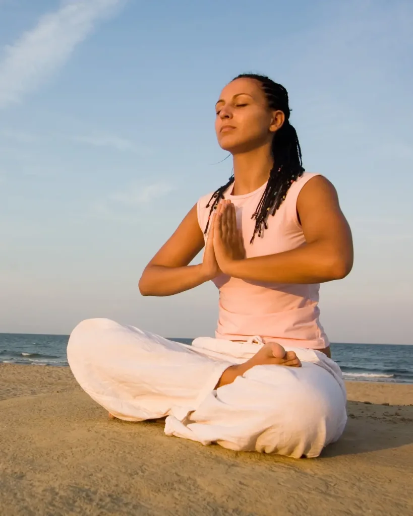 Woman Meditating on the Beach