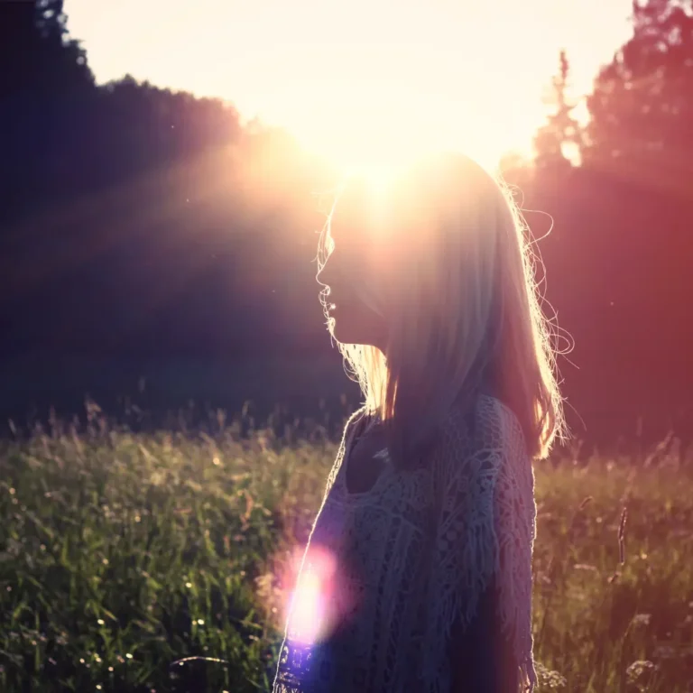 Woman Standing in Front of Sun