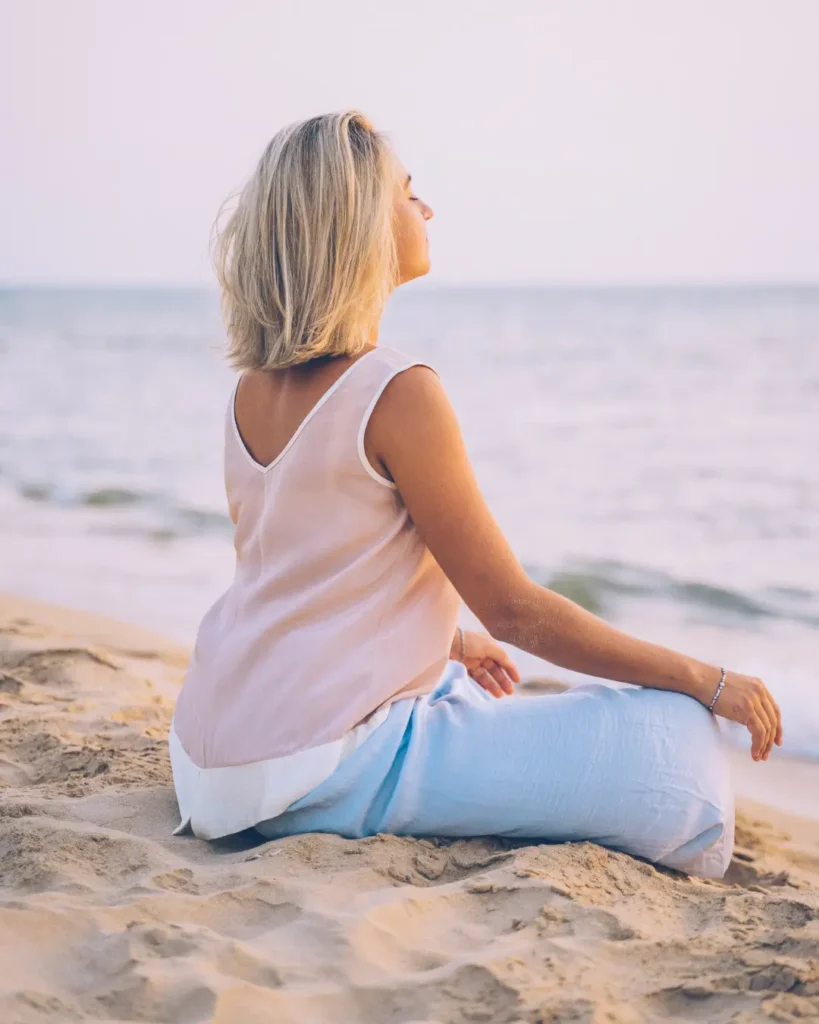 A Woman Meditating at the Beach