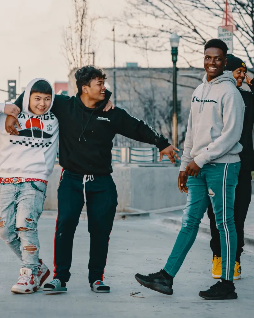 Multiethnic friends resting on street