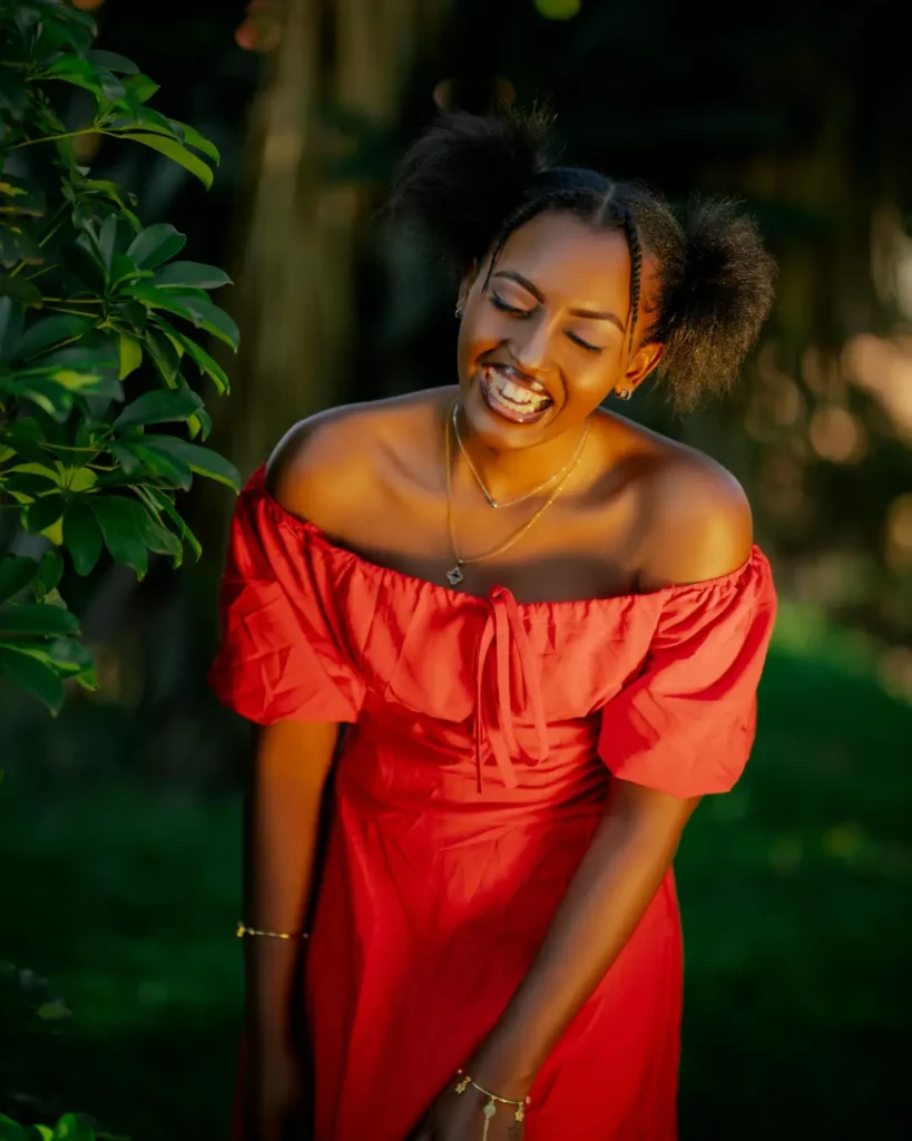 Smiling Woman in Vibrant Red Dress Outdoors