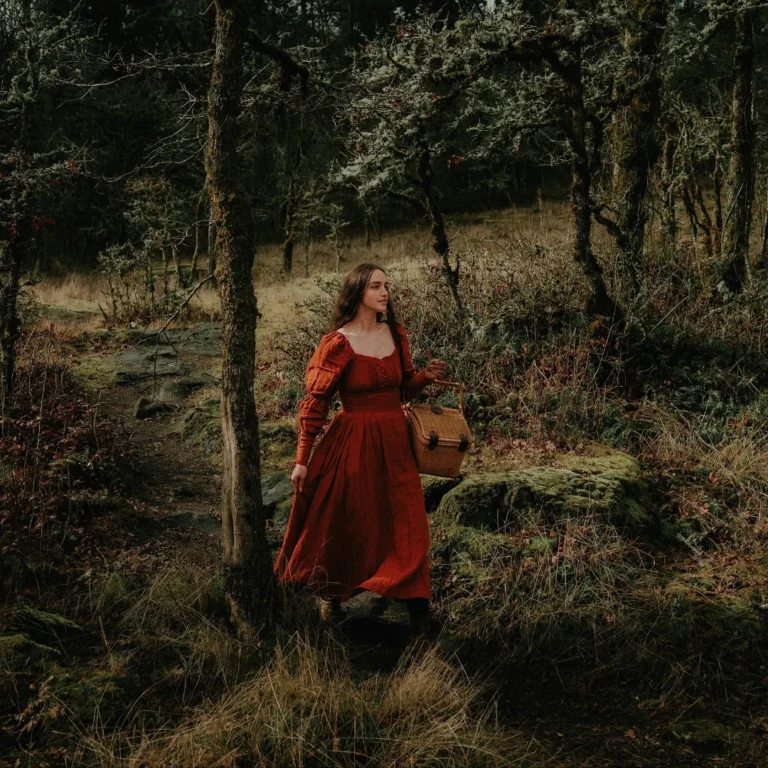 Woman in Red Medieval Dress Walking Through the Forest Carrying a Wicker Basket