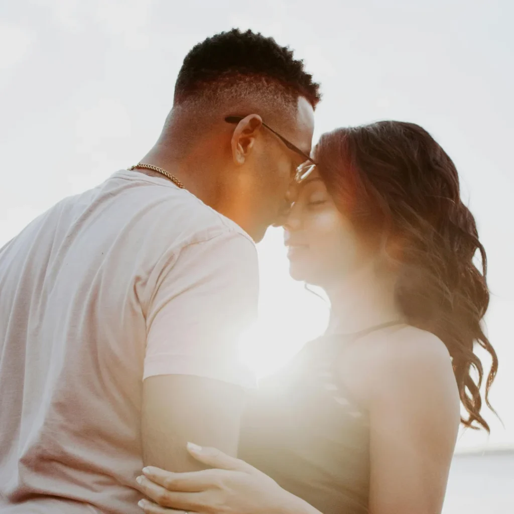 a black couple hugging with thei eyes closed. Marital Scriptures