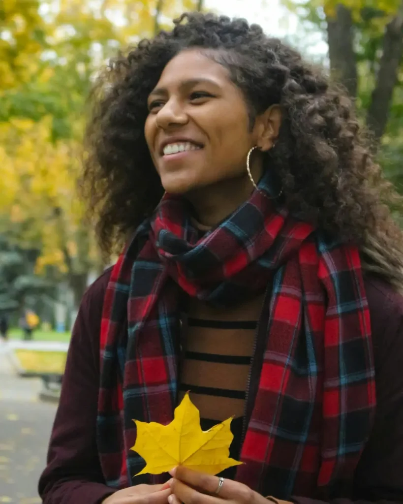 Autumn Joy_ Woman with Maple Leaf in Park
