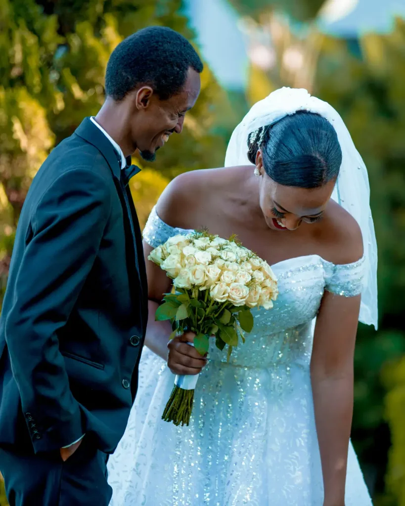Bride and Groom Standing in a Garden and Smiling