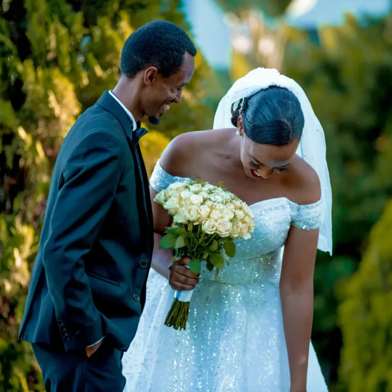 Bride and Groom Standing in a Garden and Smiling
