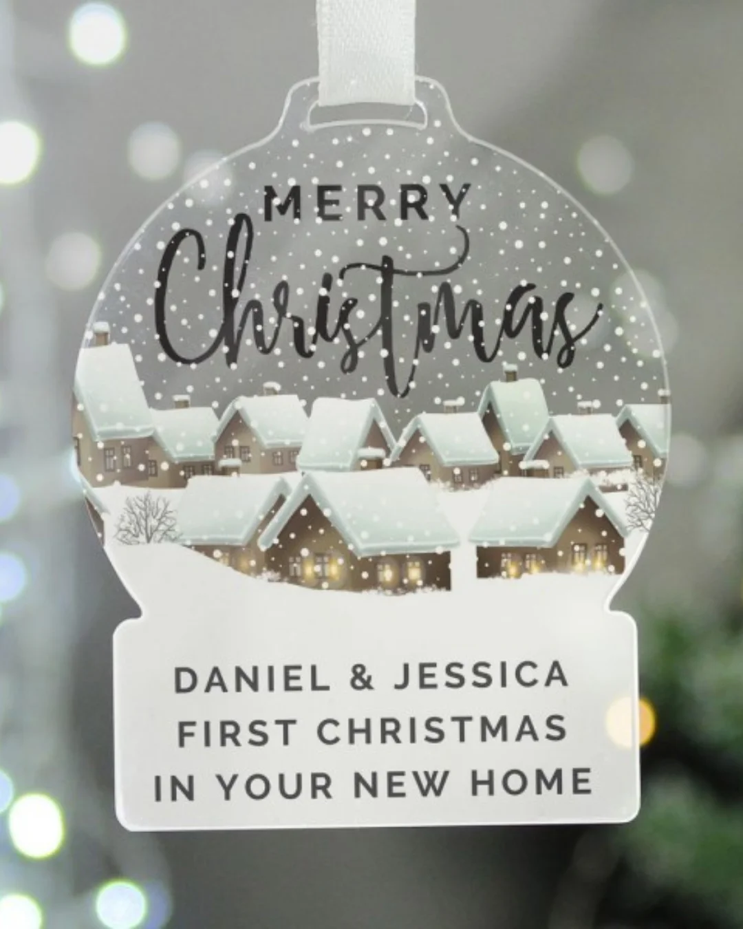 A 'New Home' Bauble with houses and snow. 