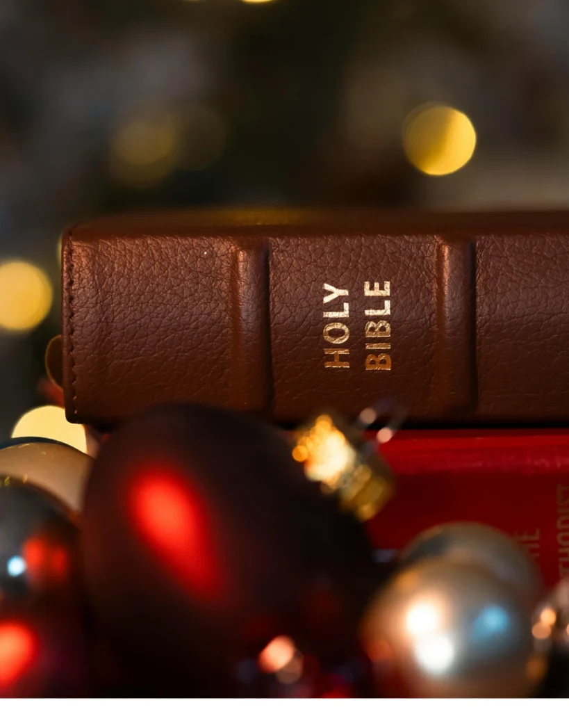 Festive Christmas Setting with Holy Bible and Ornaments