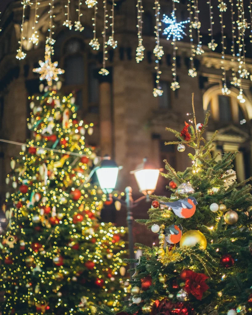 Green Christmas Tree With Baubles and String Lights.