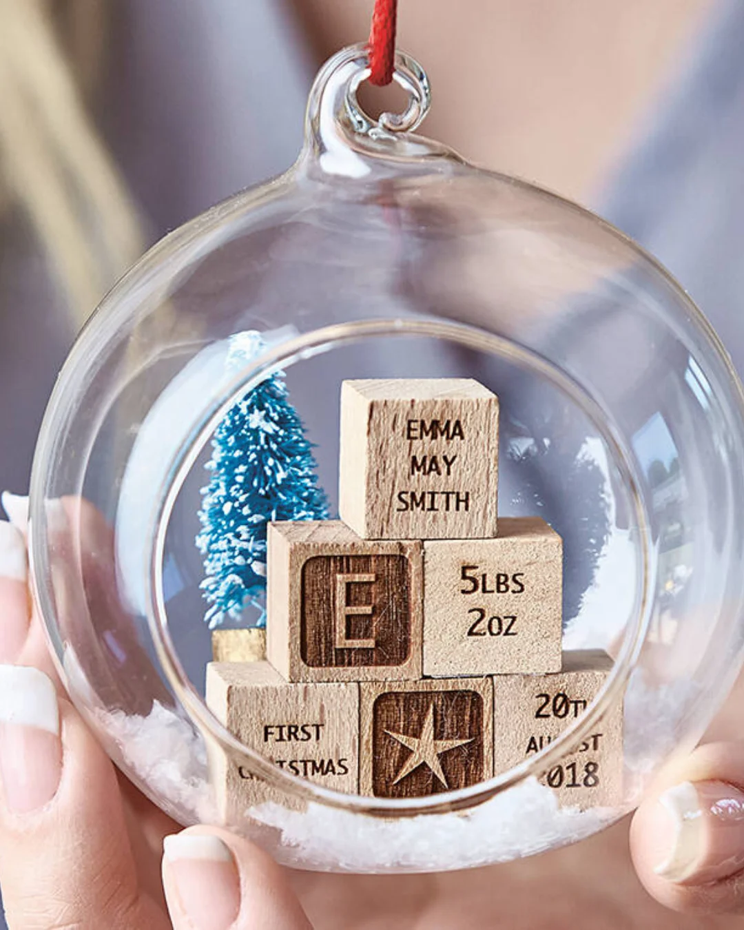 Glass bauble encloses 6 mini building blocks engraved with your personalisations, along with a mini green Christmas Tree and a dusting of faux snow.