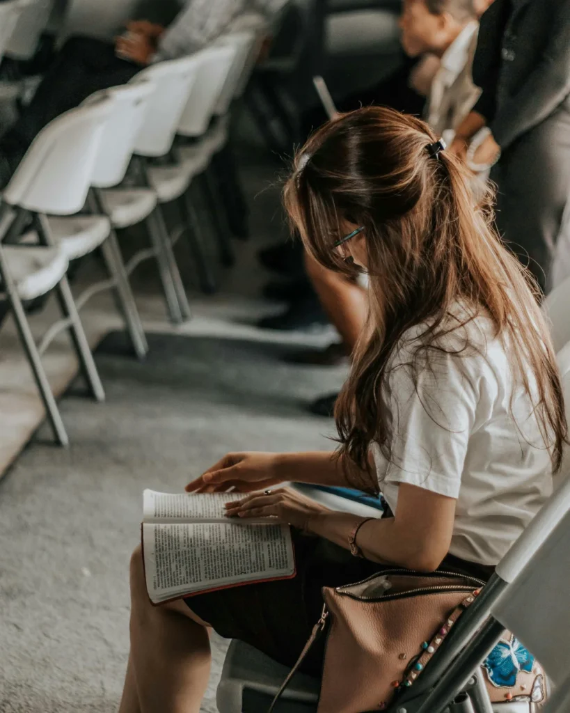 Woman sitting holding a bible