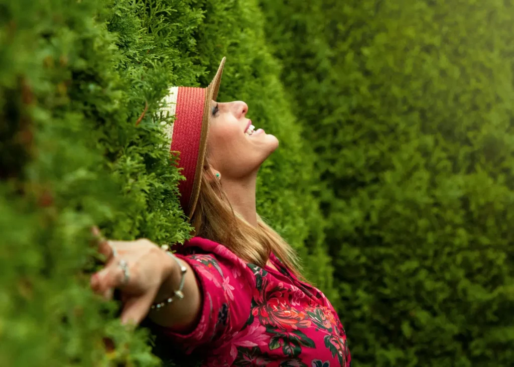 Woman in Red Floral Shirt Lying on Grass Field