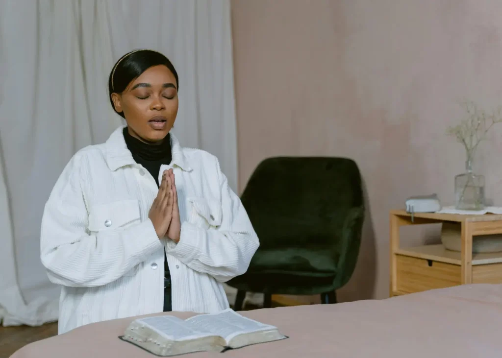 Woman in White Jacket Praying.