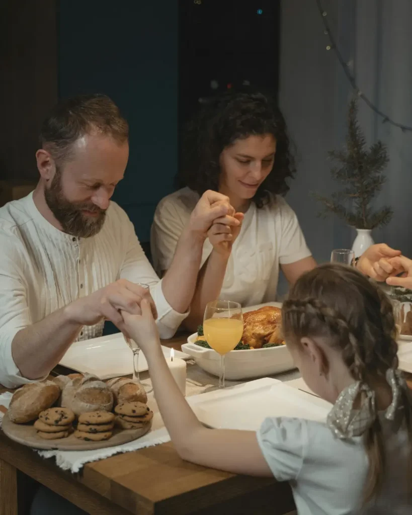A Family Holding Hand in Saying a Prayer