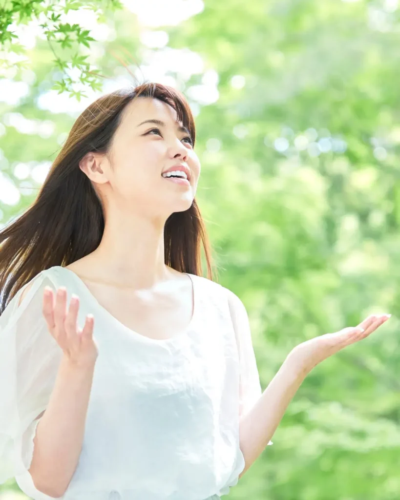 Joyful Woman with Outstretched Arms in Lush Green Park