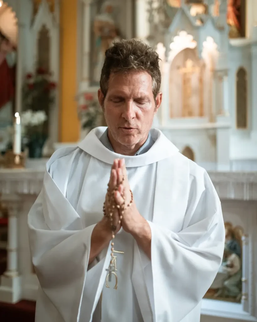 A Priest Praying inside the Church