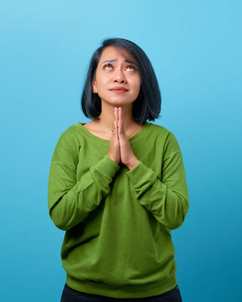 Attractive Asian Woman Wearing Casual Clothes Praying with Hope