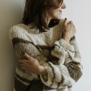 A Woman in Knit Sweater Hugging Self