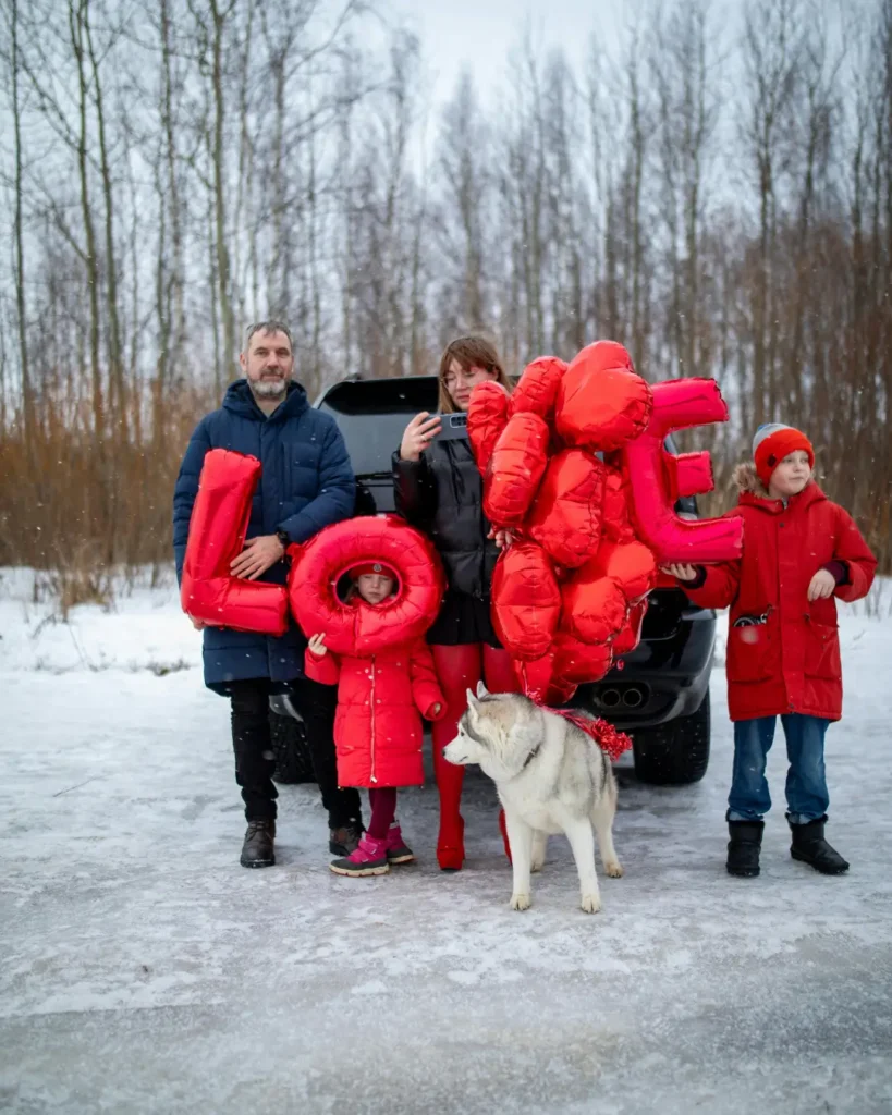 Family with Red Balloons and Dog on a Trip