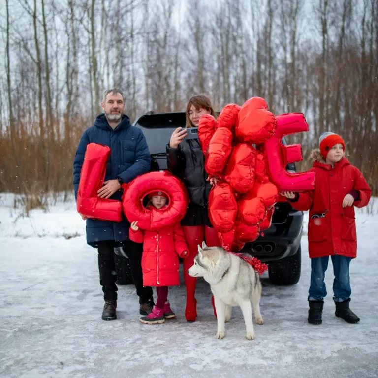 Family with Red Balloons and Dog on a Trip