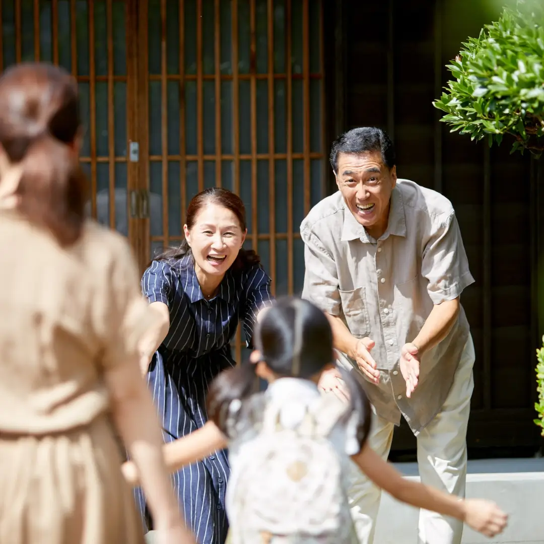 Joyful Reunion in Front of a Traditional Japanese Home