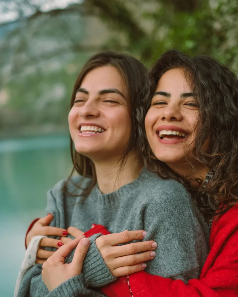 Smiling and Hugging Women
