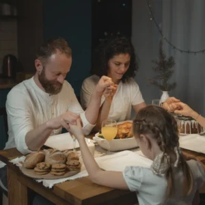 A Family Holding Hand in Saying a Prayer