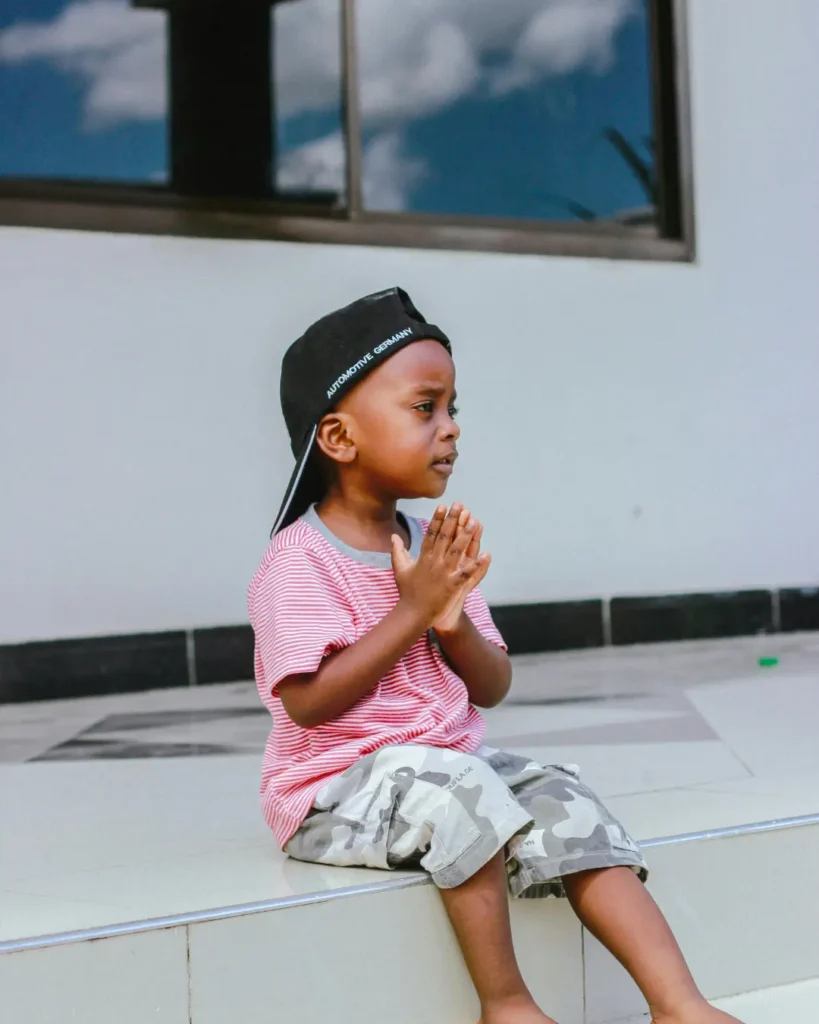 Adorable Child in Casual Outfit Sitting Outdoors
