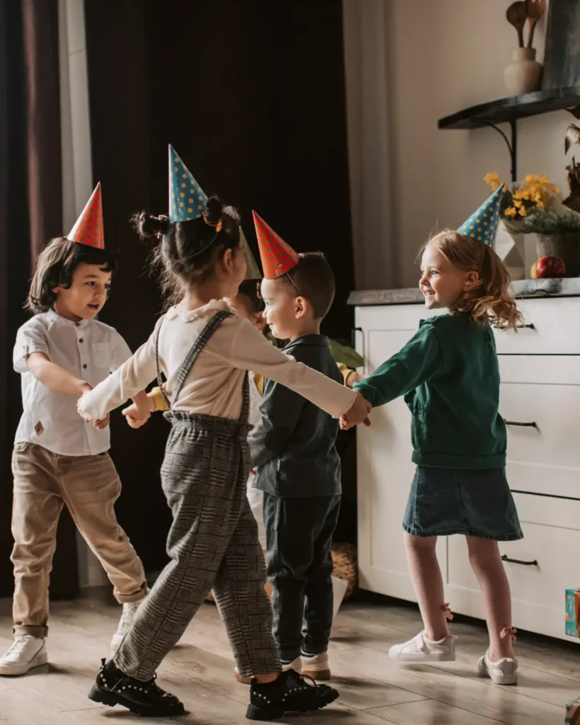 Children Standing beside White Kitchen Cabinet while Holding Hands