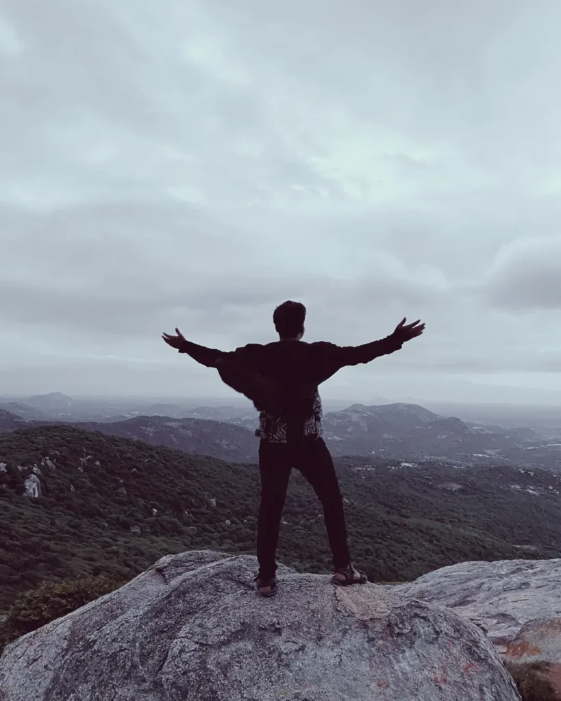 Freedom on Mountain Summit with Open Arms