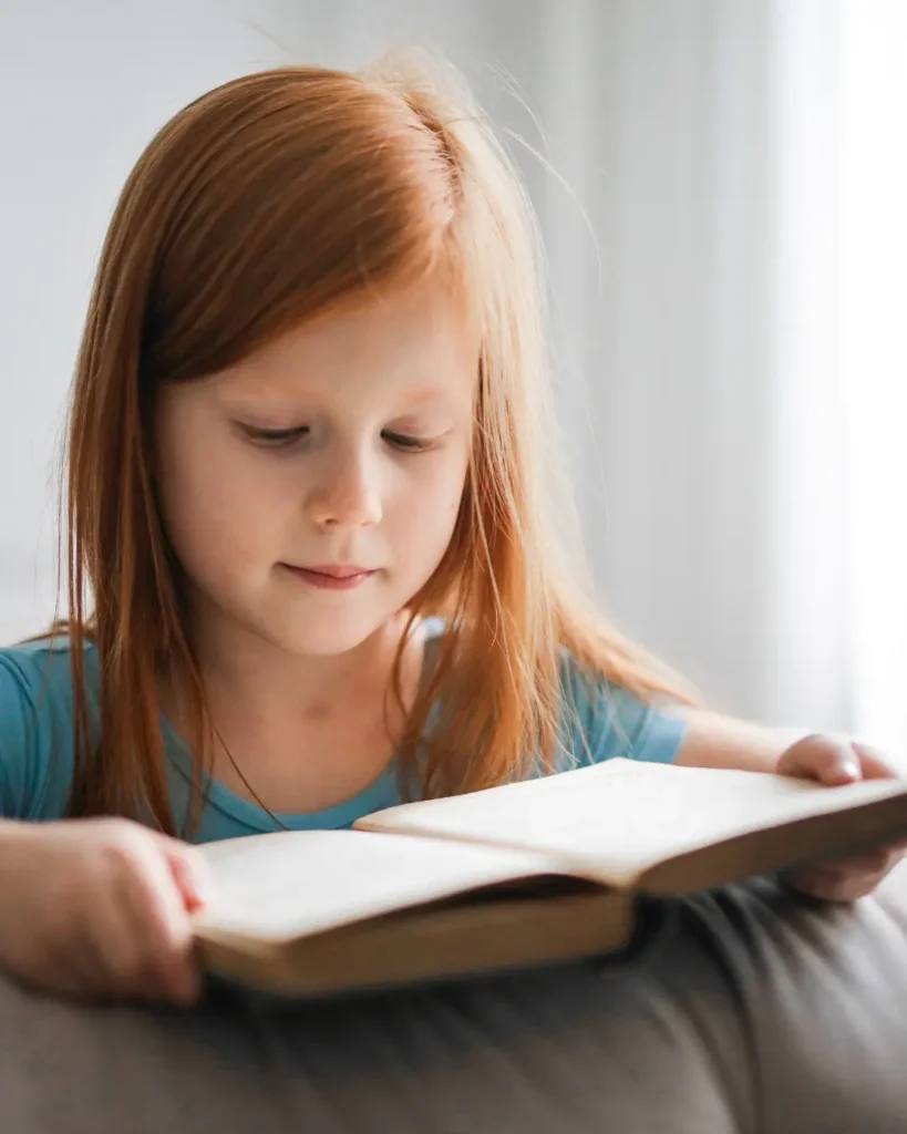 Girl in Blue T-shirt Reading Book