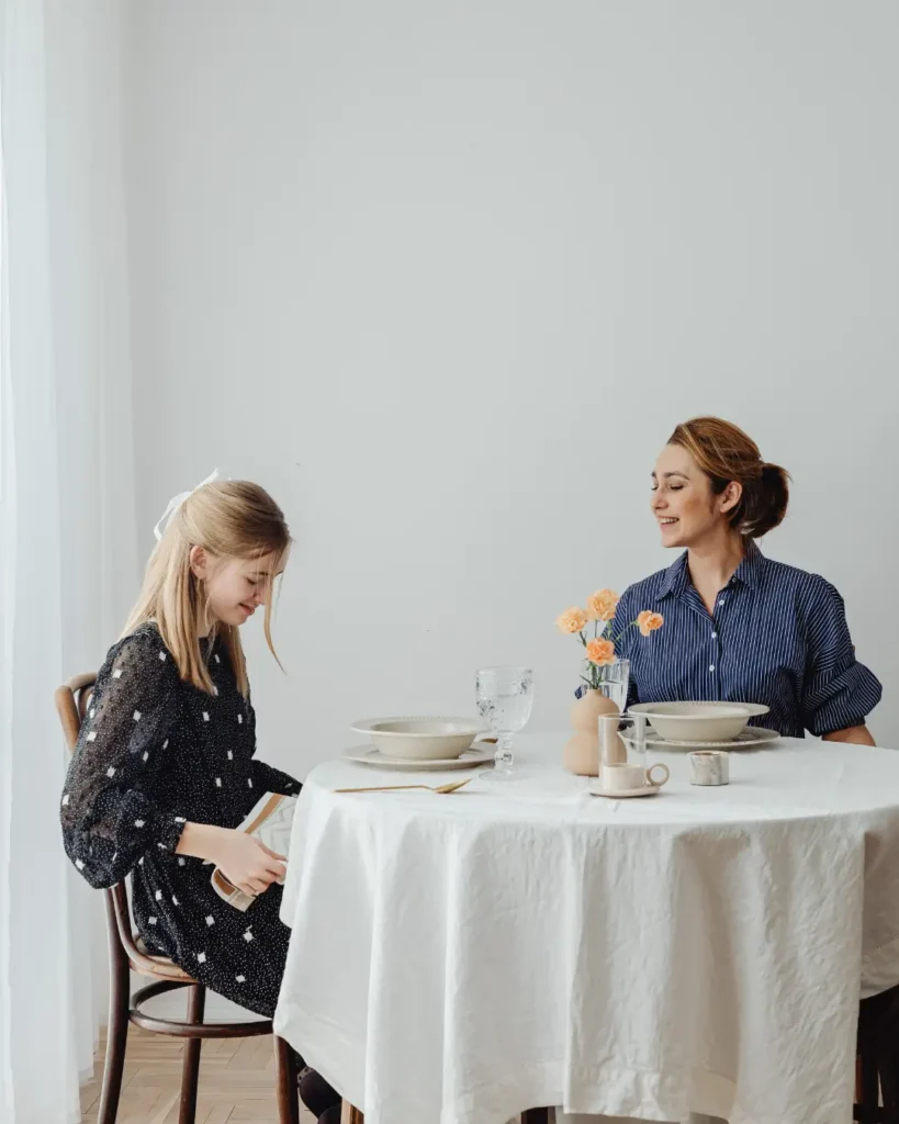 Women Sitting in Front of the Table while Having Conversation