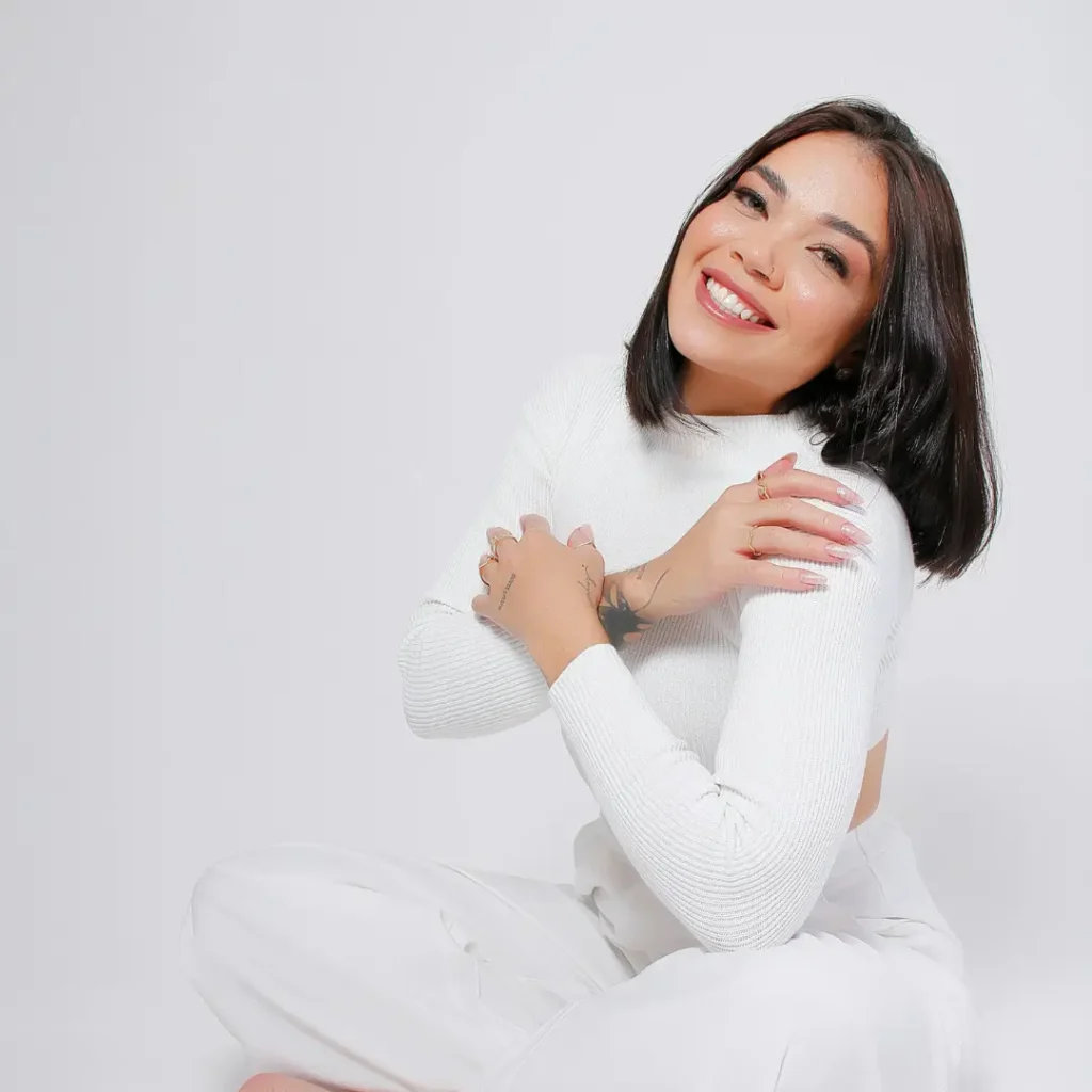 Smiling Woman in White Embracing Self-Care