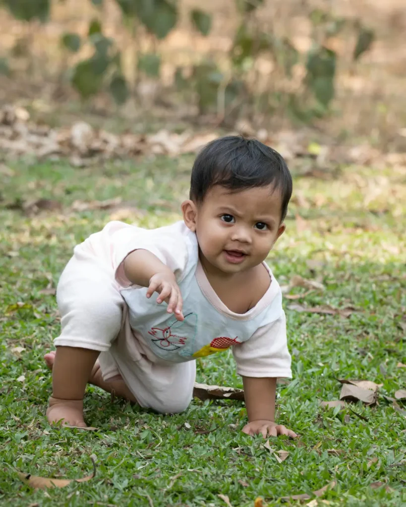 Happy Baby Crawling Outdoors in Summer Nature