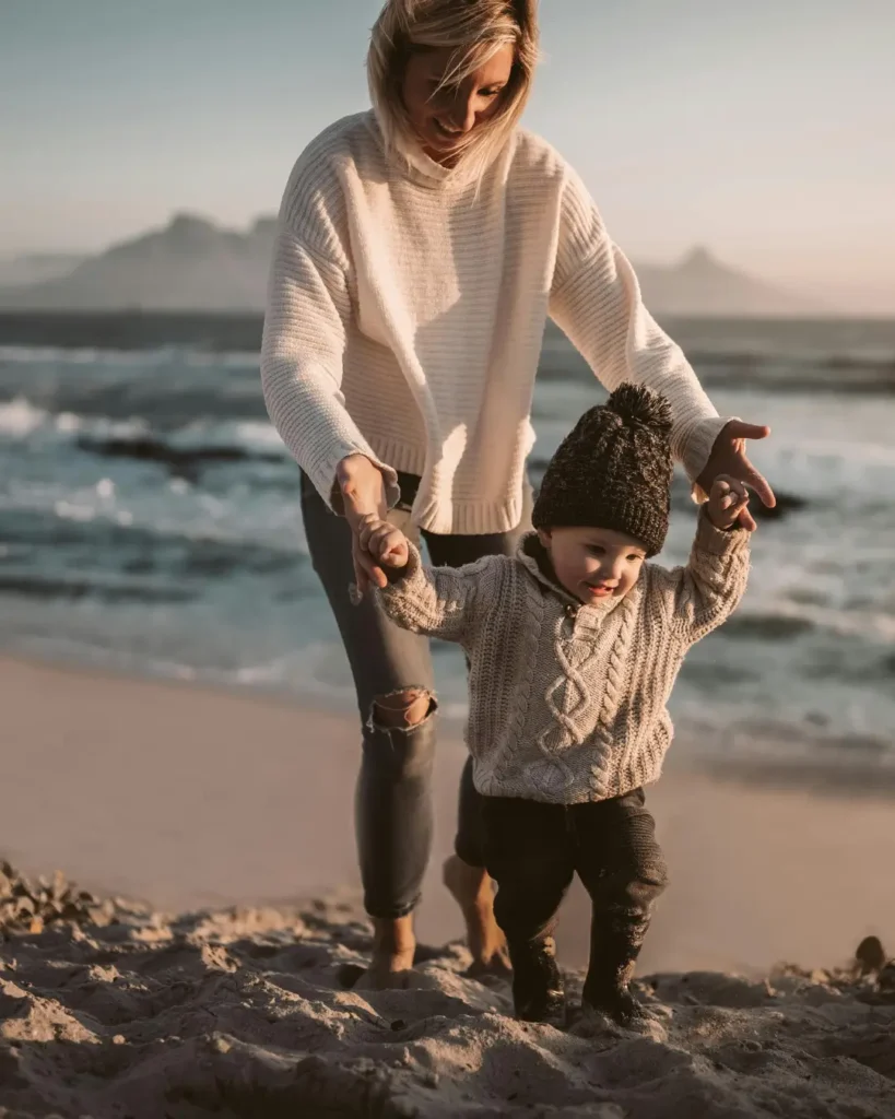 Mother and Her Child Walking on the Shore