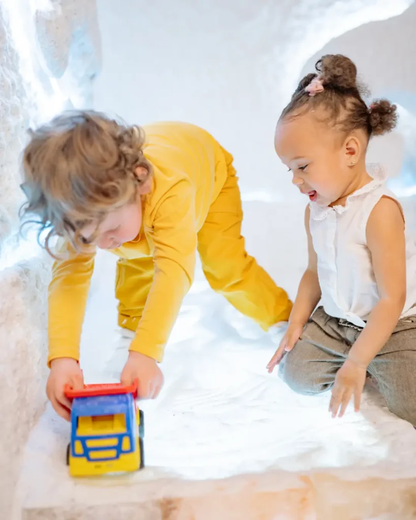 Toddlers Playing with a Toy Car