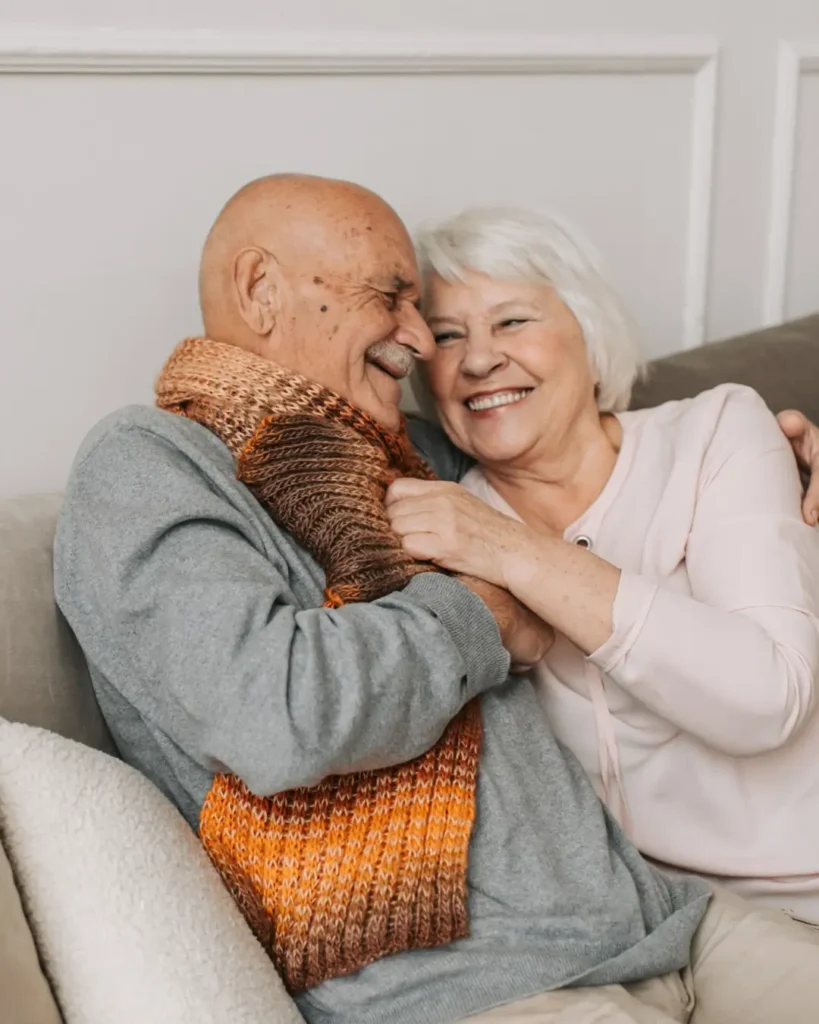 Man in Gray Sweater Hugging Woman Beside Him