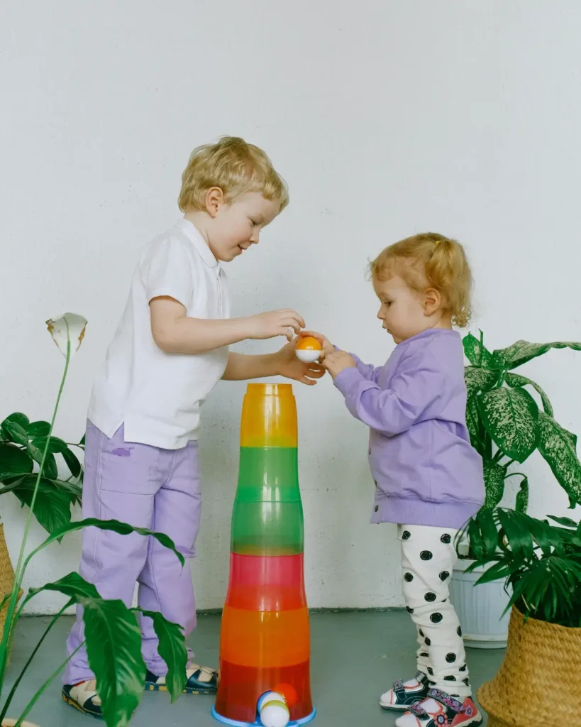 Siblings Sharing With Their Toys