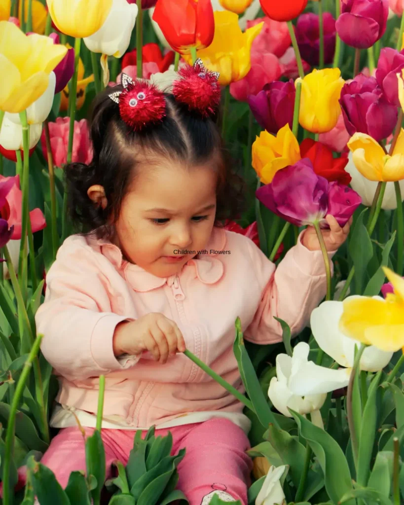 A Baby Girl Sitting on the Garden Tulips
