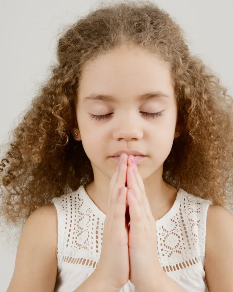 A Girl with Curly Hair Praying