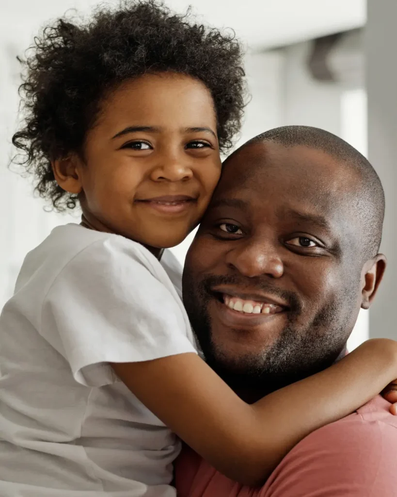 Father and Son Smiling and Looking at the Camera