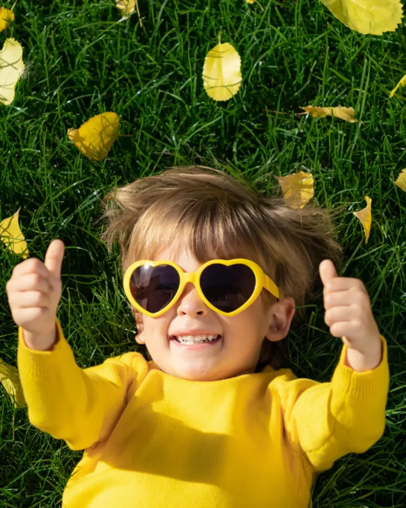 Happy Kid Having Fun While Lying on Grass