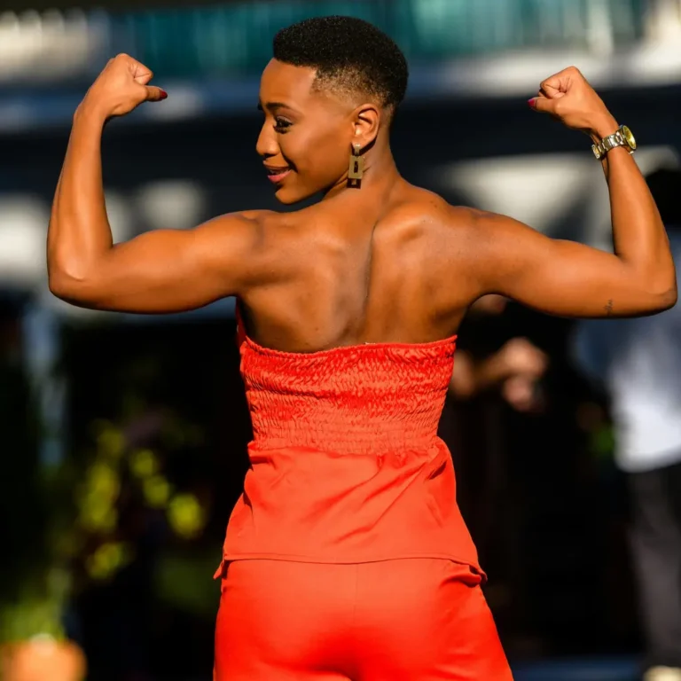 Confident Woman in Red Jumpsuit Showing Strength