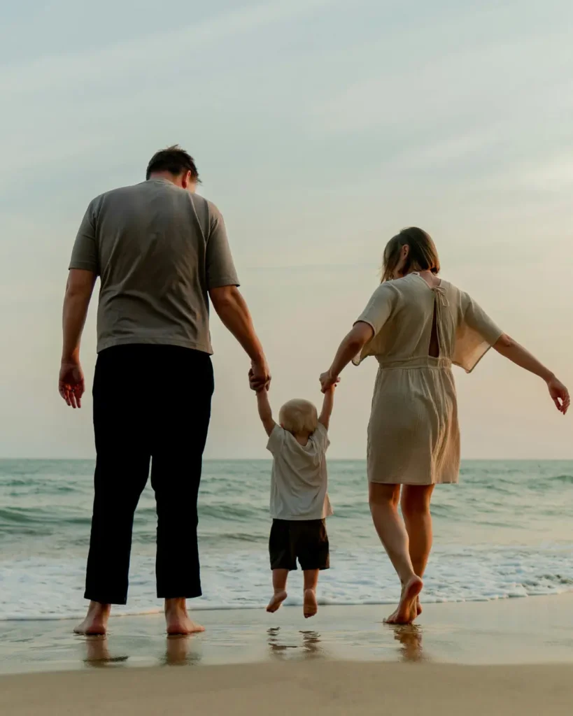 Family Walking Together on Seaside Beach