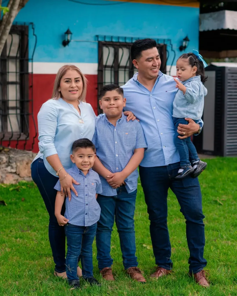 Happy Family Posing Outside a Colorful House