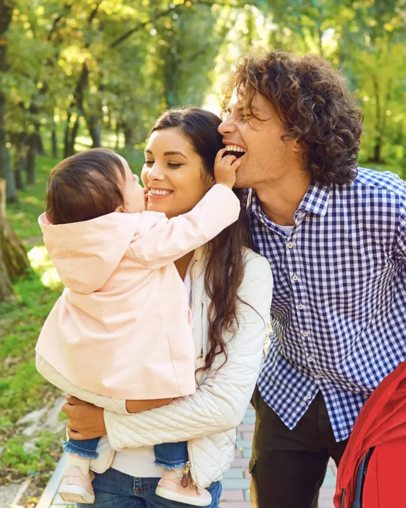 Happy Family Standing Playing in the Park