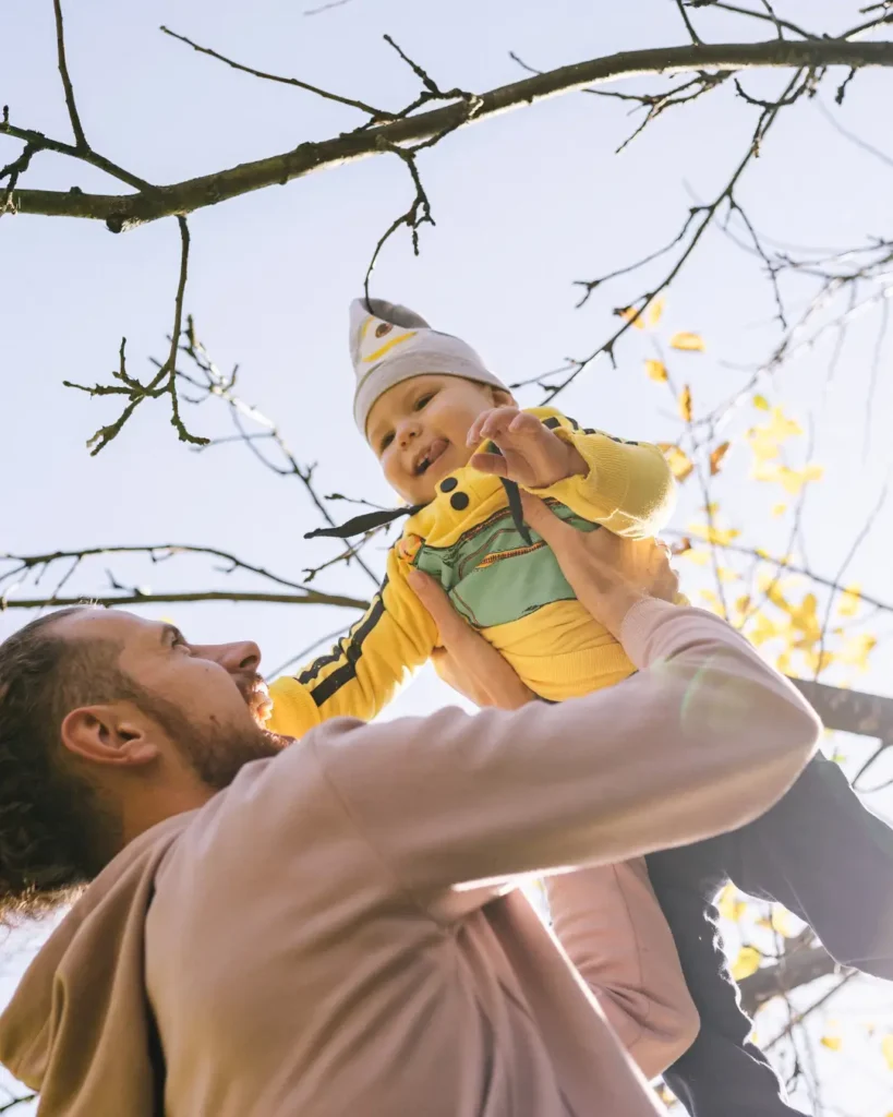 Man Carrying Baby Outside